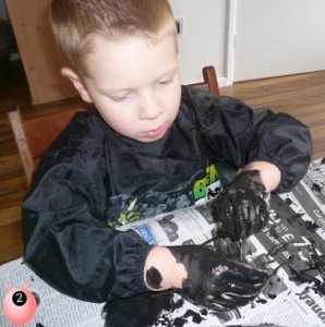 sensory seeker covering himself in black paint